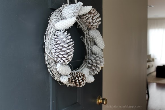 wreath made out of pine cones spray painted white