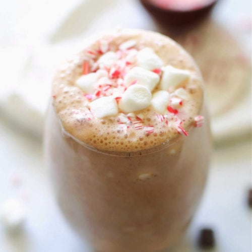 frozen hot chocolate smoothie with marshmallows and peppermint candy in a glass
