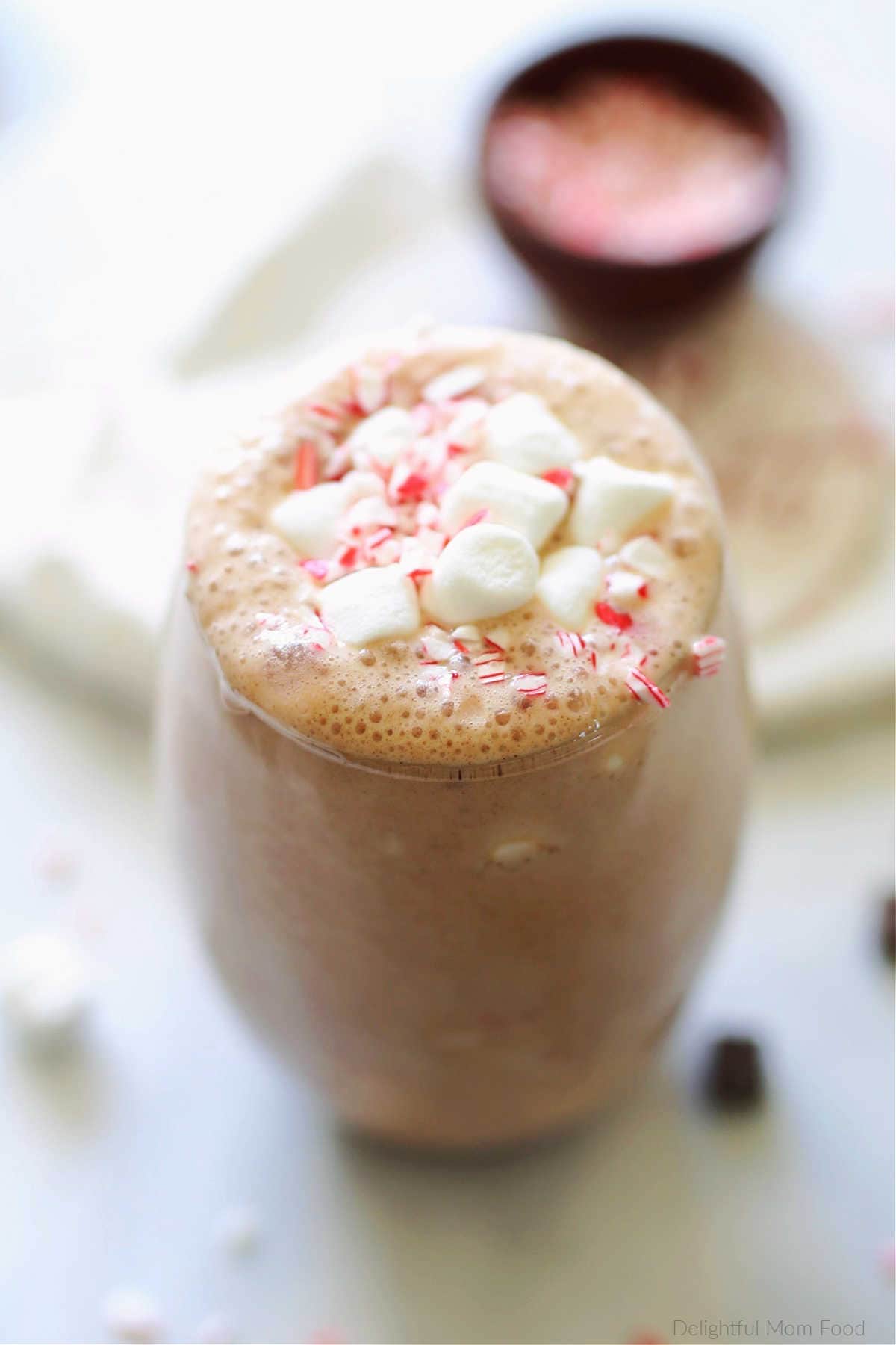 frozen hot chocolate smoothie with marshmallows and peppermint candy in a glass