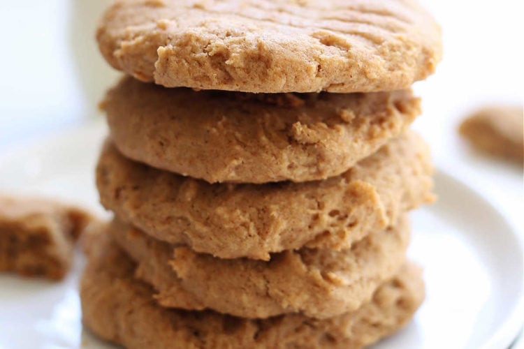 gluten free almond butter cookies stacked on a white plate