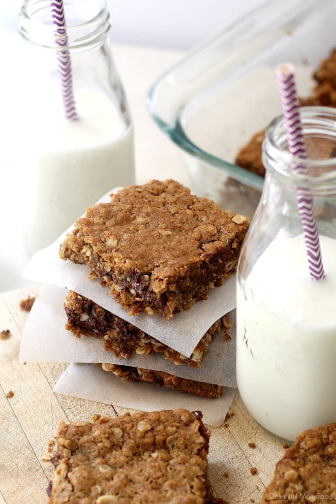 stack of gluten-free caramel chocolate bars with a glass of milk