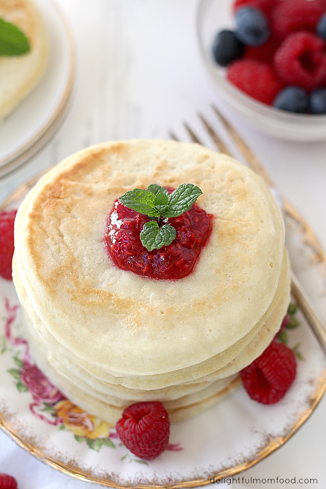 stacked pancakes with raspberry sauce