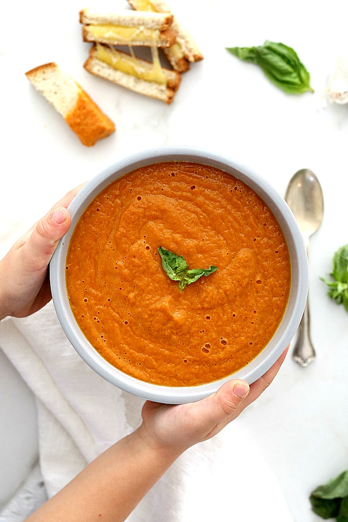 Tomato basil soup is a great way to use up fresh tomatoes and basil in an easy vegan soup!  Serve this gazpacho style or warm with gluten free grilled cheese or bread and the crowd will go wild! #tomato #basil #soup #recipe #fresh #tomatoes #glutenfree #vegan #Italian #easy #quick #gourmet | recipe at delightfulmomfood.com