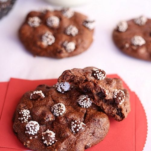 Flourless chocolate hazelnut cookies made with egg whites on a red paper.