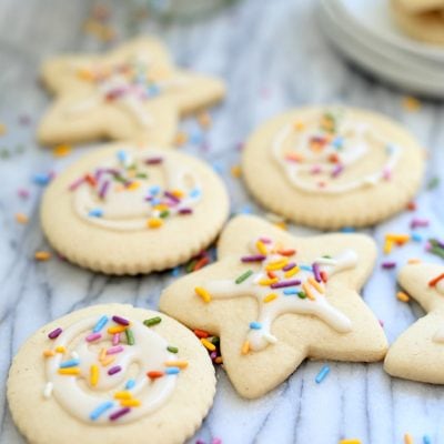 vegan gluten free sugar cookies cut out with icing and sprinkles