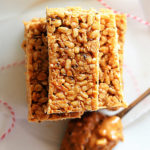 gluten-free no-bake granola bars made with peanut butter, oats, honey and cereal cut into bars and stacked on a plate