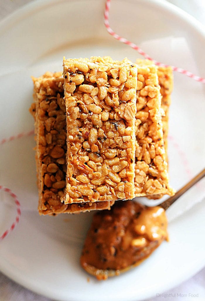 gluten-free no-bake granola bars made with peanut butter, oats, honey and cereal cut into bars and stacked on a plate