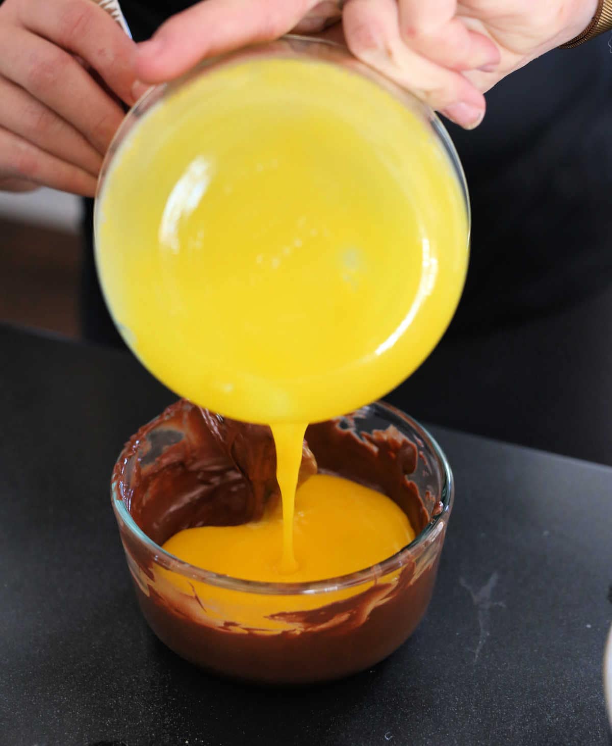 pouring eggs in melted chocolate