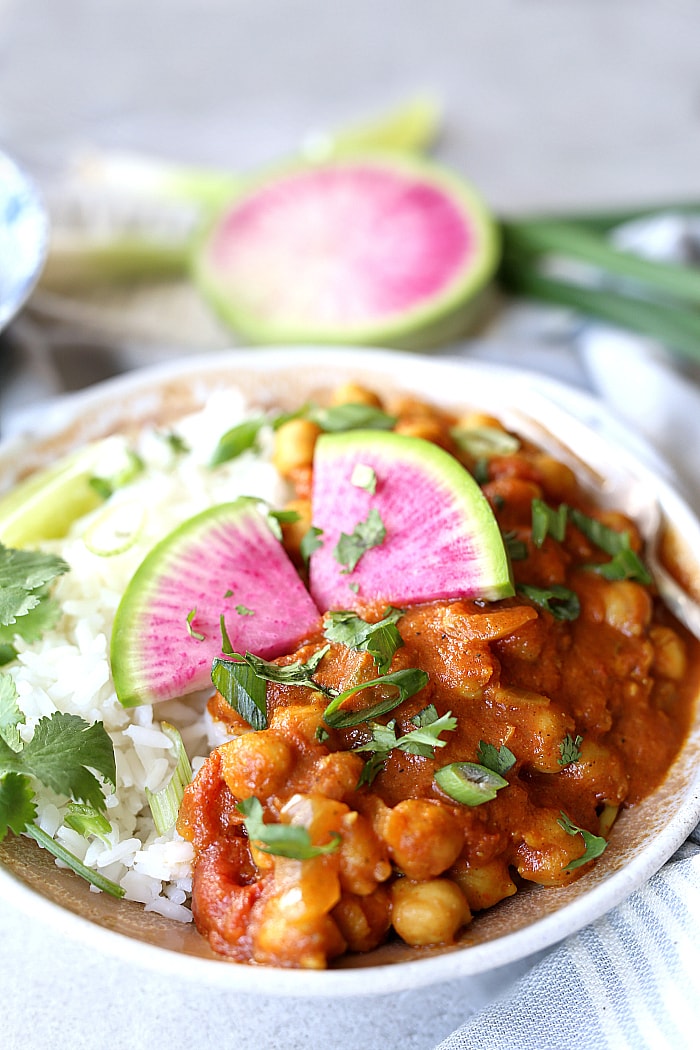 This 30-minute easy and healthy Indian Chana Masala recipe is made in 1-pot and simmered to delicious and nutritious perfection in coconut curry spices and a tomato base! Not only is it plump with chickpeas- it is vegan, gluten free and delicious tossed with rice or served with a side of roasted vegetables. #vegan #chana #masala #easy #healthy #glutenfree #chickpeas #recipe | Delightfulmomfood.com