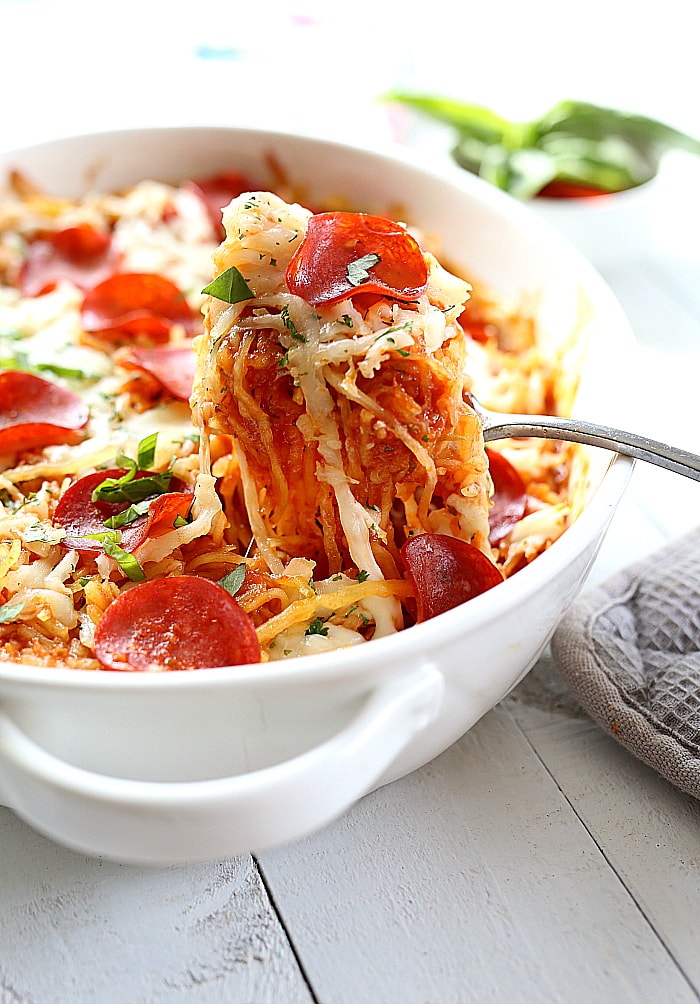 4-Ingredient baked spaghetti squash pizza casserole topped with turkey pepperoni is almost the easiest low-carb & one-dish dinner you will love! Roast a spaghetti squash ahead of time for a delicious quick dinner in 30 minutes or less!