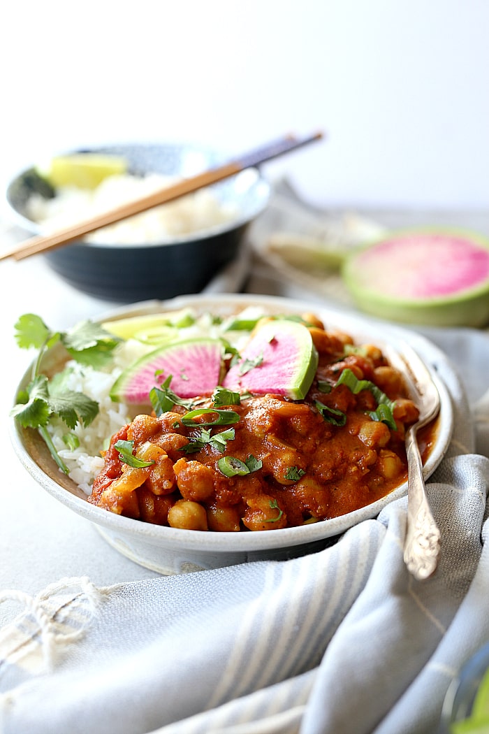Chana Masala is an easy 30-minute healthy Indian recipe! This vegan and gluten-free chickpea dish is simmered in 1-pot with coconut curry spices and a tomato base. Toss this chana masala recipe with rice or serve with a side of roasted vegetables for an irresistible dinner! #vegan #chana #masala #easy #healthy #glutenfree #chickpeas #recipe | Delightfulmomfood.com