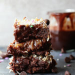 Spring just got sweeter with these easy Magic Layer Brownie Bars made with 3-ingredient Paleo brownies, coconut milk chocolate ganache, date caramel, almond slivers, white chocolate chips and toasted coconut! #tollhouse #SpringJustGotSweeter #Ad #magic #layer #brownies #glutenfree #desserts #sweets #treats | Delightfulmomfood.com