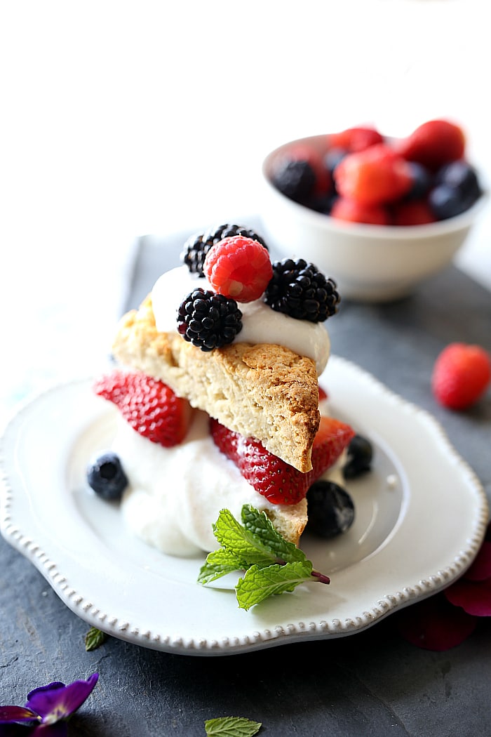 Gluten free strawberry shortcake with fresh strawberries, blueberries, blackberries and raspberries topped on a Greek yogurt honey cream filling! #strawberryshortcake #berry #recipe #glutenfree #healthy #breakfast #pastry | Delightfulmomfood.com