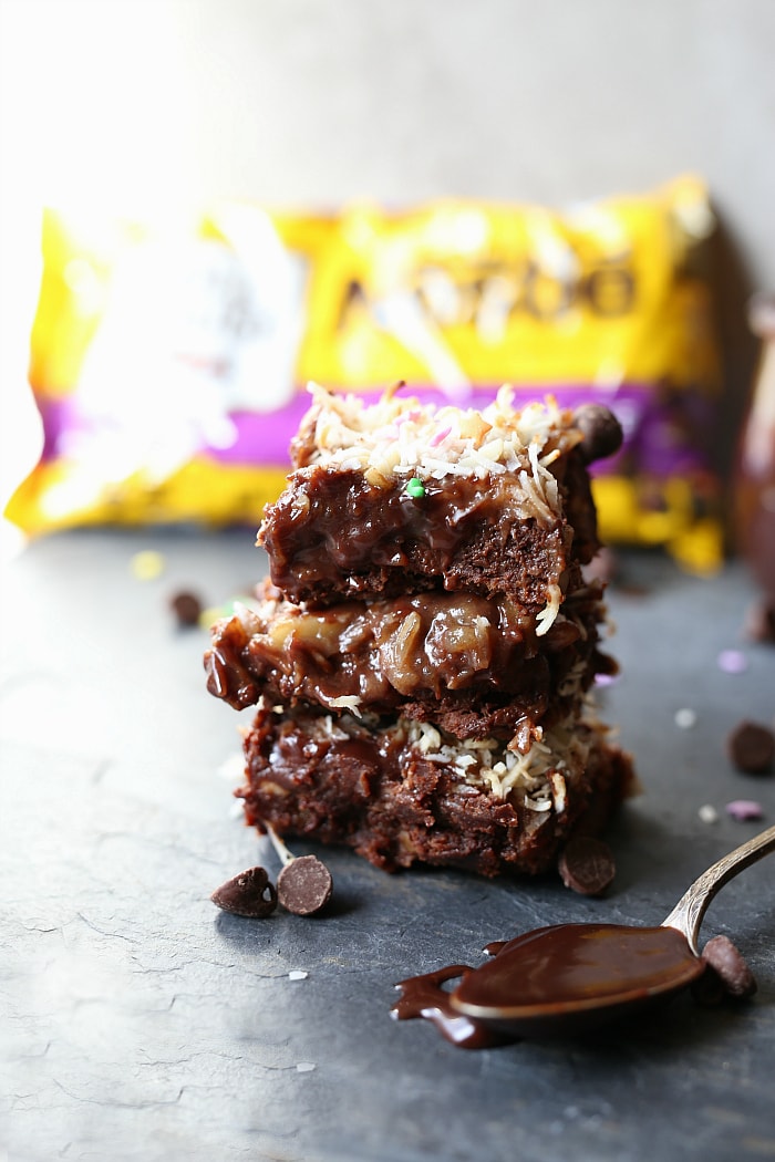 Spring just got sweeter with these easy Magic Layer Brownie Bars made with 3-ingredient Paleo brownies, coconut milk chocolate ganache, date caramel, almond slivers, white chocolate chips and toasted coconut! #tollhouse #SpringJustGotSweeter #Ad #magic #layer #brownies #glutenfree #desserts #sweets #treats | Delightfulmomfood.com