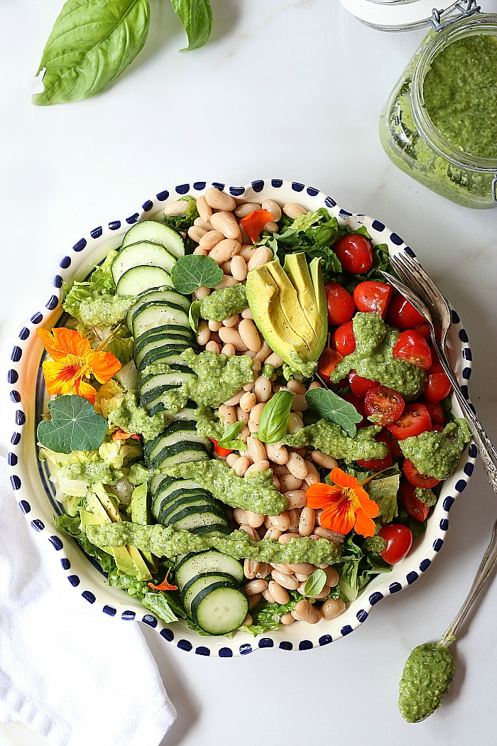 Simple salad made with white beans, plump tomatoes, cucumbers, and a creamy avocado broccoli pesto dressing. This vegan salad is easy to put together and the perfect plant-based meal to detox and build lean muscles. #plantbased #simple #healthy #salad #vegan #vegetarian #whitebean #tomato #cucumber #paleo #whole30 #lowcarb #keto | Recipe at delightfulmomfood.com