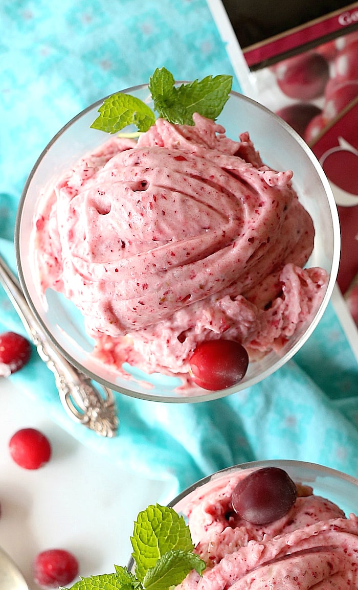 This cranberry ice cream is sure to soothe a sweet tooth craving! The berry’s bittersweet taste mixed with sweet frozen bananas and topped with (vegan) butter rum chocolate sauce is a healthier way to enjoy a frozen treat! #icecream #frozen #dessert #treats #fruit #cranberry #recipe #banana #capecodselect #frozencranberries #cranberriesforallseasons | Recipe at delightfulmomfood.com