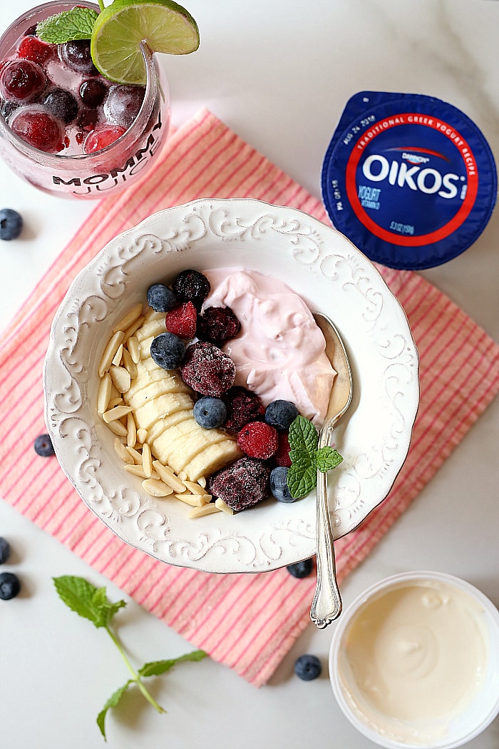 Greek yogurt bowl - packed with healthy probiotics, fiber and protein to fuel the body and fill you up for hours! Enriched with antioxidant berries, bananas and almonds makes this healthy yogurt bowl a balanced and delicious breakfast or snack. #snack #healthy #breakfast #Greekyogurt #glutenfree #ad #NotJustAHint #OikosAtWalmart | Recipe at delightfulmomfood.com