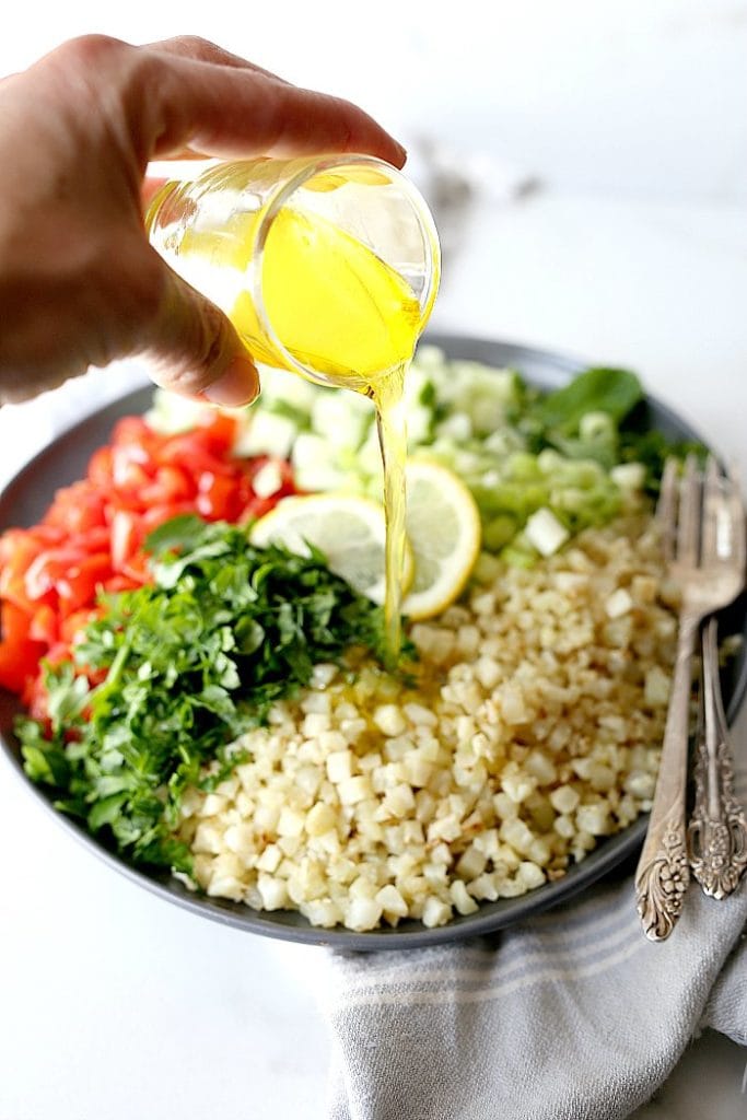 Cauliflower tabbouleh is an excellent substitute for a grain-free dish using cauliflower rice! Tabbouleh is a staple vegetarian salad of the Middle East served cold with fresh parsley, tomatoes and a light olive oil dressing. #cauliflower #tabbouleh #tabbouli #side #recipe #healthy #glutenfree #lowcarb #paleo #whole30 #vegan #vegetarian | Recipe at delightfulmomfood.com