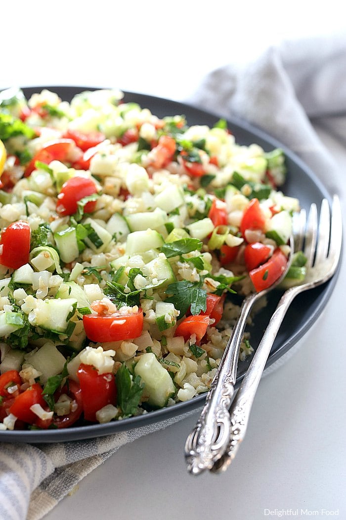 Cauliflower tabbouleh is an excellent substitute for a grain-free dish using cauliflower rice! Tabbouleh is a staple vegetarian salad of the Middle East served cold with fresh parsley, tomatoes and a light olive oil dressing. #cauliflower #tabbouleh #tabbouli #side #recipe #healthy #glutenfree #lowcarb #paleo #whole30 #vegan #vegetarian | Recipe at delightfulmomfood.com