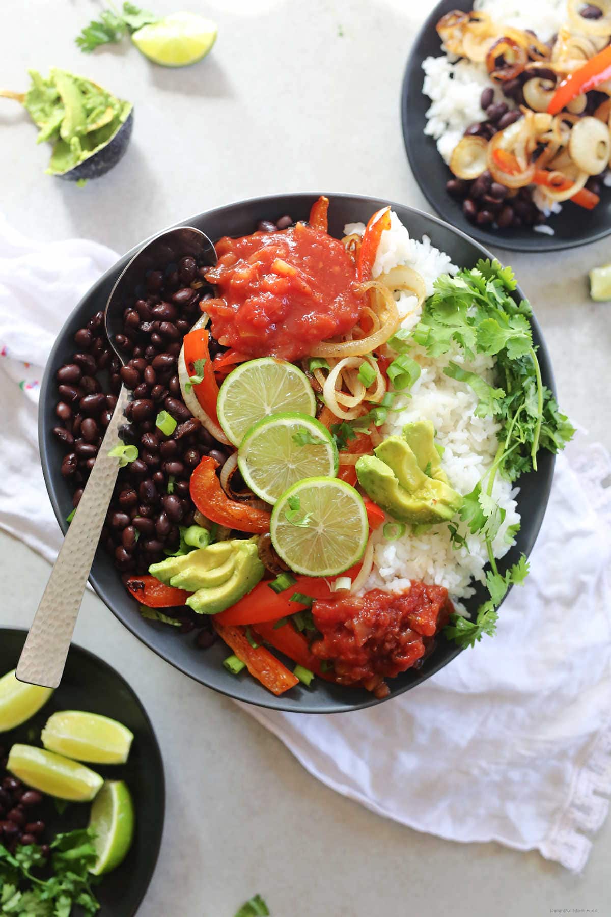 Vegetarian burrito bowl ready with zesty Mexican flavors in less than 30 minutes! It is the ultimate gluten-free healthy fajita burrito bowl layered with sautéed peppers and onions over warm rice and beans! #healthy #fajita #burrito #bowl #easy #quick #glutenfree #vegan #vegetarian #rice #beans #Mexican #recipe #entree #main | Recipe at delightfulmomfood.com