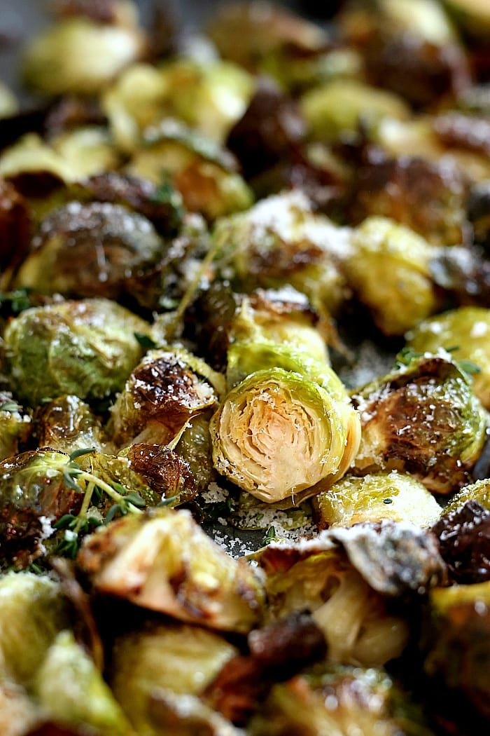 Oven roasted brussels sprouts tossed and baked in flavorful oil, salt and pepper. This easy side dish is gluten-free, vegetarian and for a bonus is delicious topped with freshly grated Parmesan cheese or nutritional yeast. #brusselssprouts #recipe #oven #roasted #quick #healthy #glutenfree #vegan #vegetarian #sidedish | recipe at delightfulmomfood.com