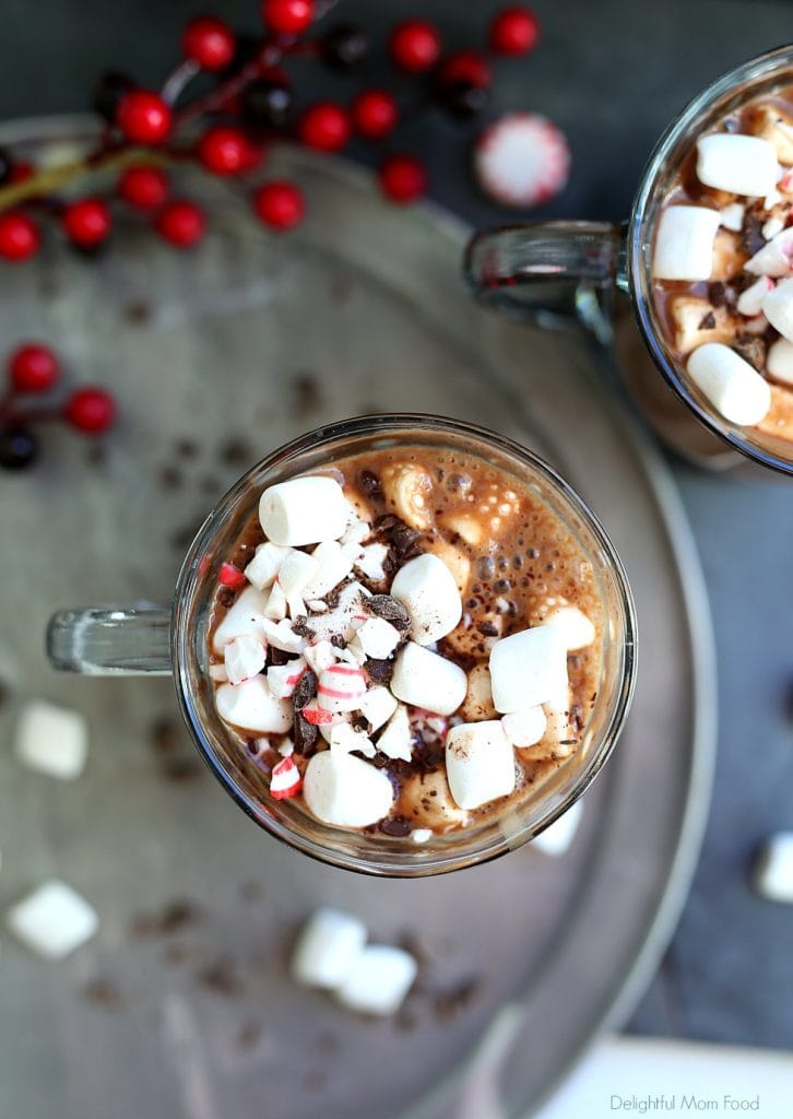 top of a warm cup of dairy-free hot cocoa showing marshmallows, peppermint and dairy-free chocolate shavings