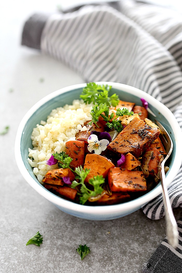 Savory roasted sweet potatoes, carrots and onion over cauliflower rice is a family favorite buddha bowl ready in minutes! This buddha bowl is deliciously packed with irresistible flavors and caters to most diets including gluten-free, Whole 30, Paleo and vegan! #glutenfree #buddhabowl #roasted #sweetpotatoes #carrots #sheetpan #easy #cauliflowerrice #whole30 #vegan #vegetarian | Recipe at delightfulmomfood.com