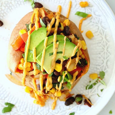Vegan Mexican stuffed sweet potatoes with drizzled spicy southwest sauce! The starchy sweet vegetables are so good for you and stuffed sweet potatoes are easy to create! #Mexican #stuffed #sweetpotatoes #recipe #food #glutenfree #vegan #easy #quick #healthy #potatoes | Recipe at delightfulmomfood.com