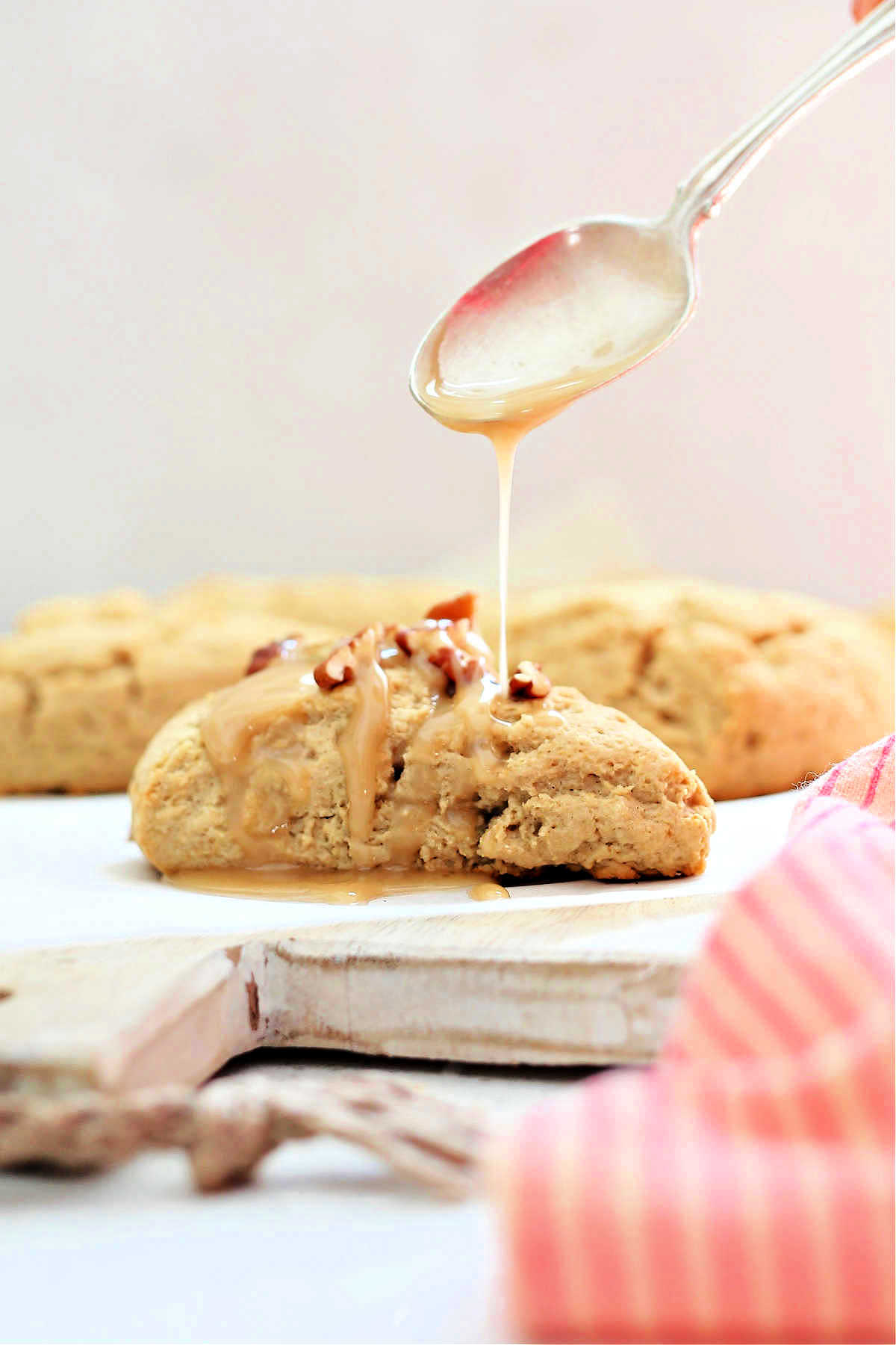 best gluten-free scones with a spoon drizzling maple glaze on top