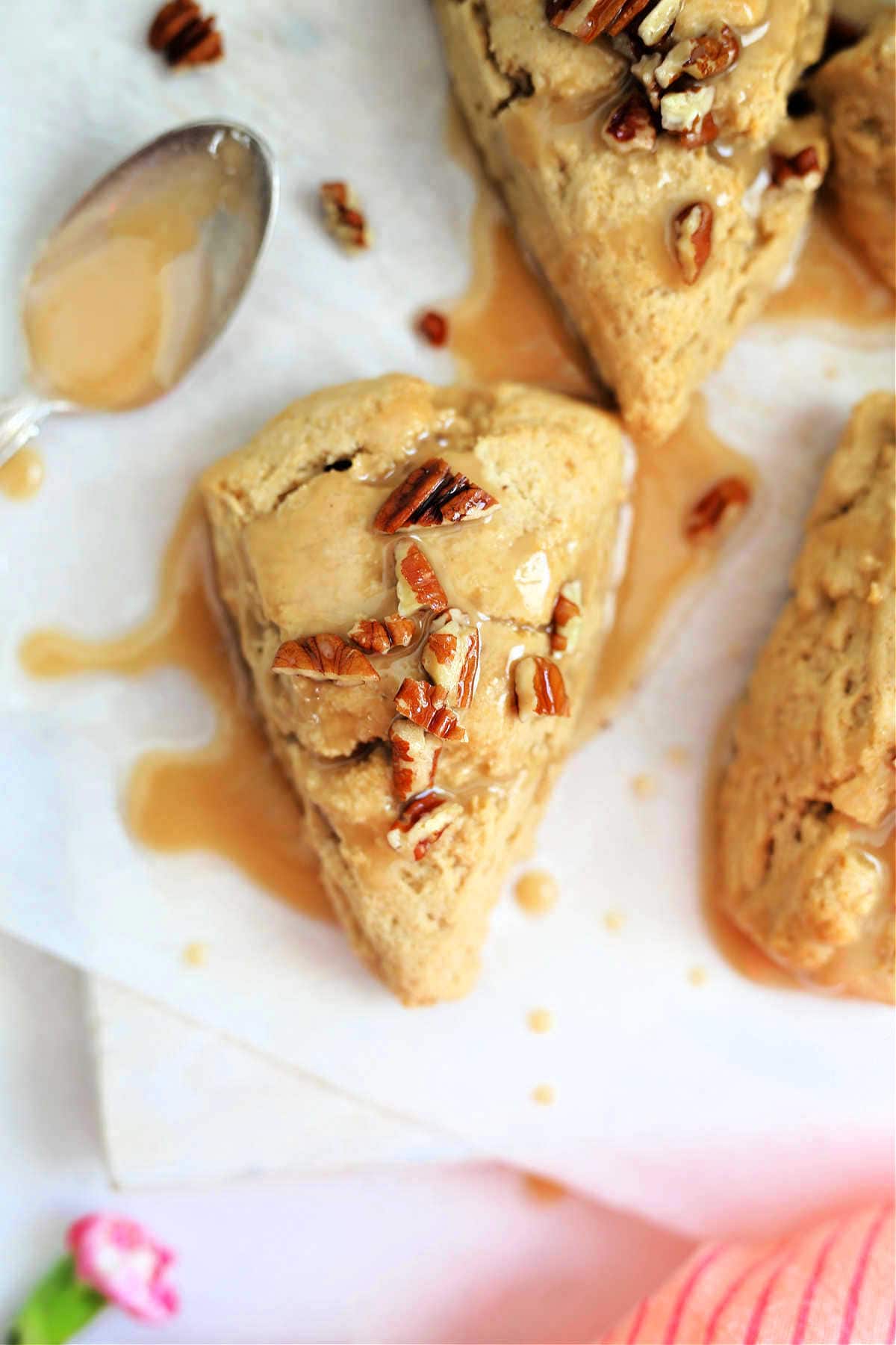 gluten-free scone topped with maple drizzle and pecan nuts