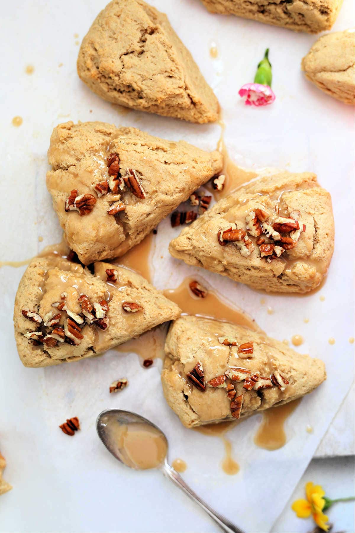 the best gluten free scones recipe topped with pecans on parchment paper with a spoon