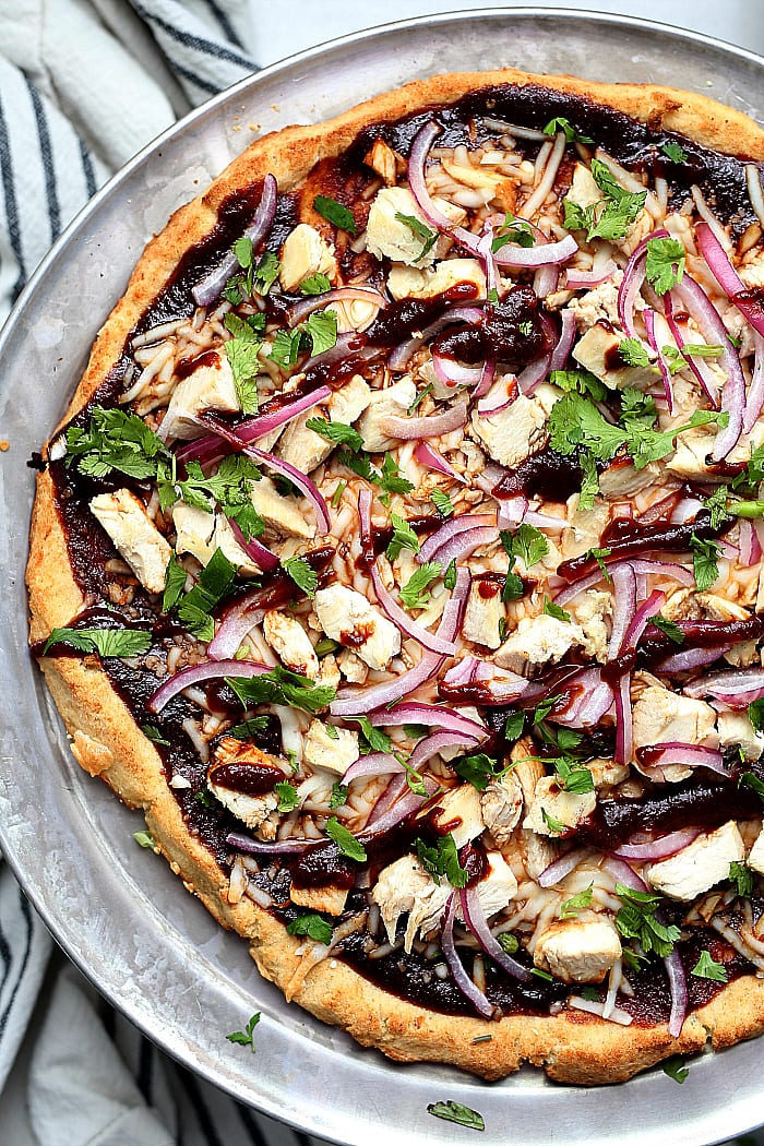 Barbecue Chicken Cauliflower Crust Pizza! How about a good pizza recipe without the bloated feeling after eating it?! 😊 This cauliflower crust BBQ chicken pizza is so flavorful, crispy, thin, light and your gut will thank you! It is packed with vegetables and protein and a copycat Trader Joe's cauliflower crust. delightfulmomfood.com #cauliflower #rice #pizza #glutenfree #crust #cauliflowerpizzacrust #healthy #dairyfree #barbecue #chicken #bbq #recipe