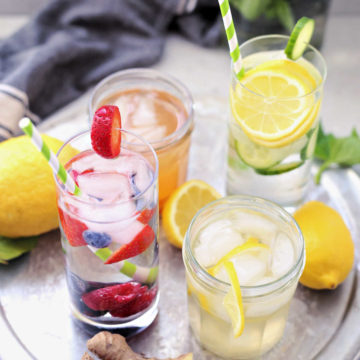 four detox water recipes to heal your gut and transform your body, drink on a tray in glasses