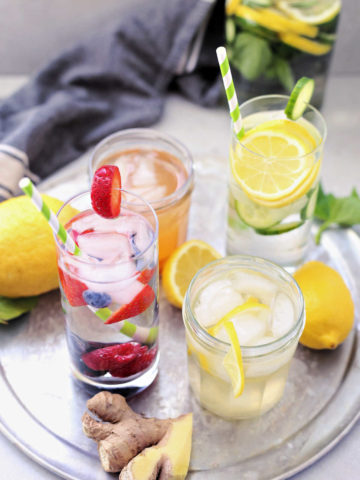 four detox water recipes to heal your gut and transform your body, drink on a tray in glasses