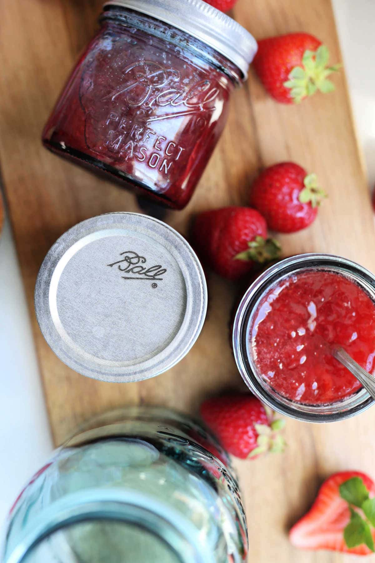 strawberry jam recipe in Ball canning jars with fresh strawberries