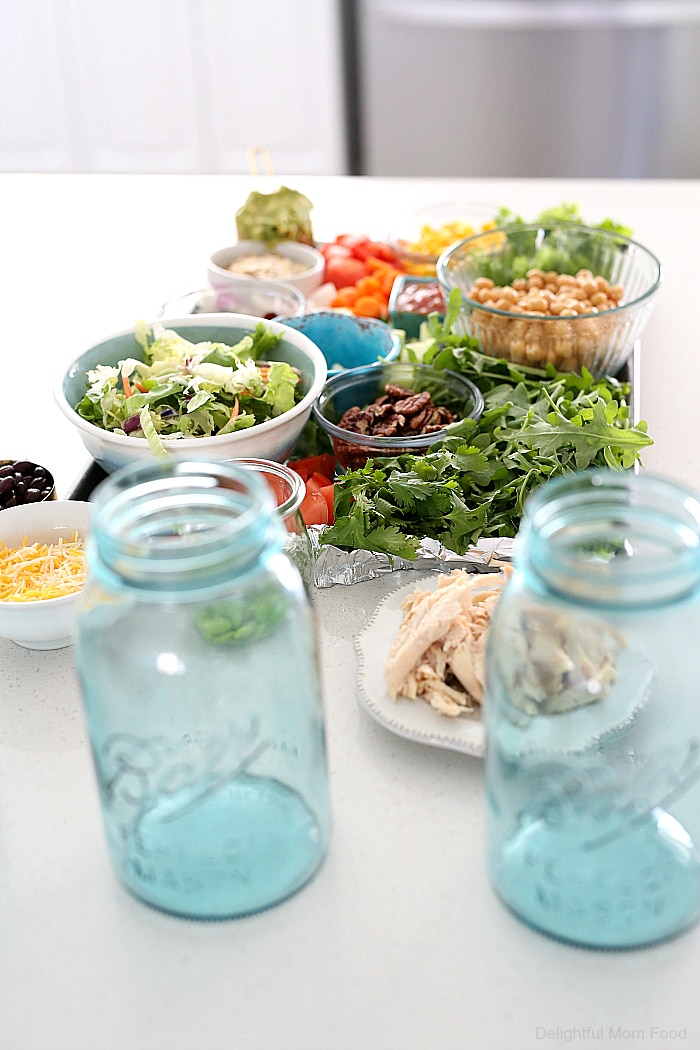 Meal prepping salads just got easier by layering them in mason jars. It keeps all the ingredients fresh but there is a trick to how to prepare it to stay fresh. Check out these 4 delicious meal prep ideas creating a salad in a jar! #mealprep #ideas #saladinajar #masonjarsalads #mealprepideas #glutenfree #healthy #recipes | Recipes at Delightful Mom Food