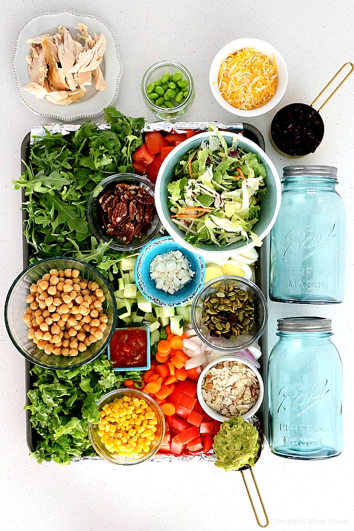 Meal prepping salads just got easier by layering them in mason jars. It keeps all the ingredients fresh but there is a trick to how to prepare it to stay fresh. Check out these 4 delicious meal prep ideas creating a salad in a jar! #mealprep #ideas #saladinajar #masonjarsalads #mealprepideas #glutenfree #healthy #recipes | Recipes at Delightful Mom Food