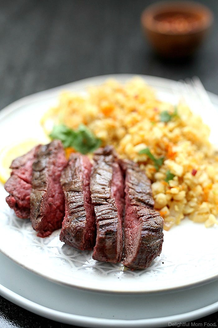 Tender top sirloin steak recipe with a buttery crisp exterior and rich juicy flavors. This hearty sirloin steak served with zesty cauliflower rice is a 30 minutes or less meal that is Paleo, Keto and Whole 30 friendly!  #whole30 #keto #paleo #30minutemeals #dinner #recipe #glutenfree #dairyfree #topsirloinsteak #steak #entree | Recipe at Delightful Mom Food