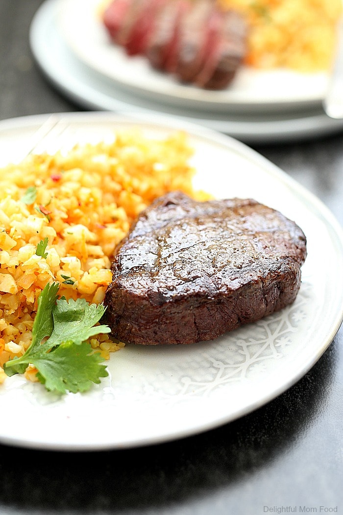 Tender top sirloin steak recipe with a buttery crisp exterior and rich juicy flavors. This hearty sirloin steak served with zesty cauliflower rice is a 30 minutes or less meal that is Paleo, Keto and Whole 30 friendly!  #whole30 #keto #paleo #30minutemeals #dinner #recipe #glutenfree #dairyfree #topsirloinsteak #steak #entree | Recipe at Delightful Mom Food