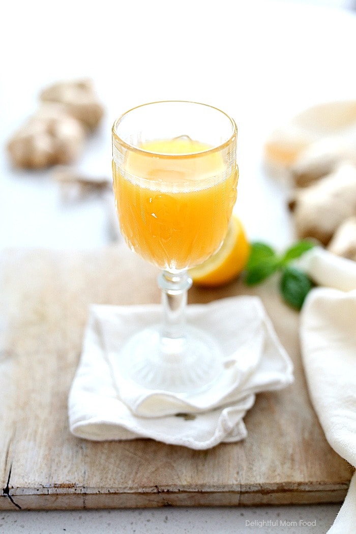 Drinking this concentrated fresh + cleansing wellness shot made of metabolism boosting cayenne pepper, lemon, ginger and apple improves digestion, skin, fights colds and flu and aids to reduce inflammation! It is a quick and easy immunity blast to jumpstart the body for optimal health! #wellness #detox #lemon #wellnessshot #drink #beverage #cleanse #bodycleanse #wellnessshot #immunityshot #ginger #shot #recipe #healthy #healing | Recipe at Delightful Mom Food
