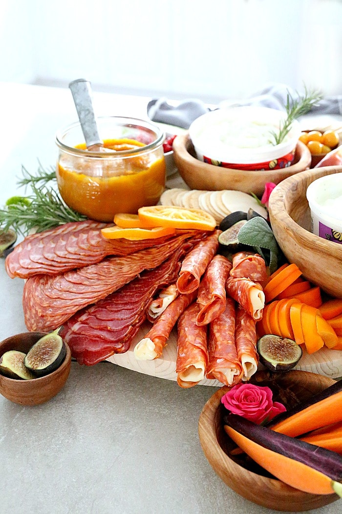 Celebrate and host a party with this Charcuterie board! This winning Charcuterie platter is loaded with meats, dried fruit, the perfect dips, gluten-free crackers and tips on how to make the perfect holiday Charcuterie board- the greatest focal point to every party!  #charcuterieboard #charcuterie #glutenfree #recipe #wholesome #appetizer | Recipe at Delightful Mom Food 