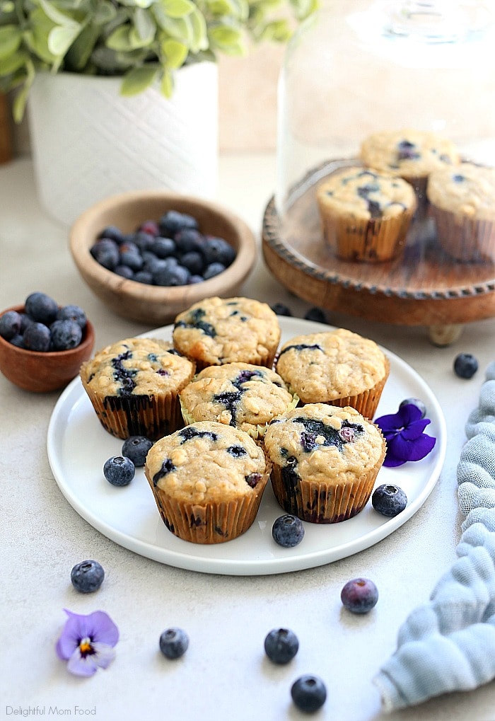 The fluffiest gluten free blueberry muffins recipe! These healthy and easy blueberry oat muffins are seriously the best gluten-free muffins! They are also dairy-free and packed with fiber, juicy blueberries, rolled oats and a hint of lemon zest. #glutenfree #muffins #recipe #healthy #oats #oatmeal #breakfast #brunch #snack #baking #dairyfree #blueberry #blueberries #delightfulmomfood | Recipe at Delightful Mom Food