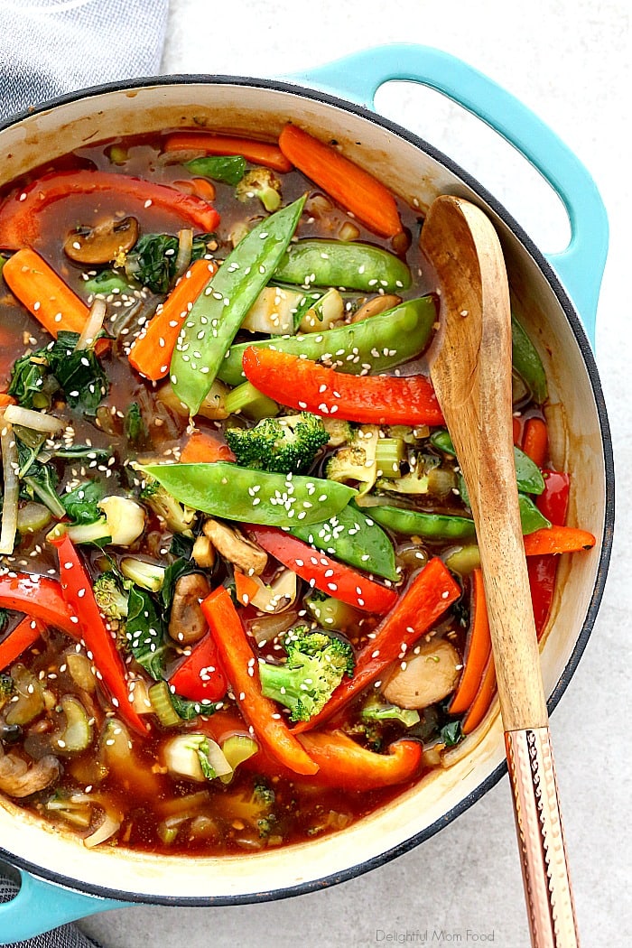 A savory, gingery and healthy stir fry vegetables recipe made with chunks of carrots, snow peas, onion, mushrooms, celery, broccoli, red peppers, and bok choy tossed in the best stir fry sauce! Serve these stir fry veggies for a quick dinner over rice, quinoa or as a side. #healthyvegetablestirfry #vegetablestirfry #stirfryrecipe #stirfryveggies #stirfryvegetables #delightfulmomfood | Recipe at Delightful Mom Food