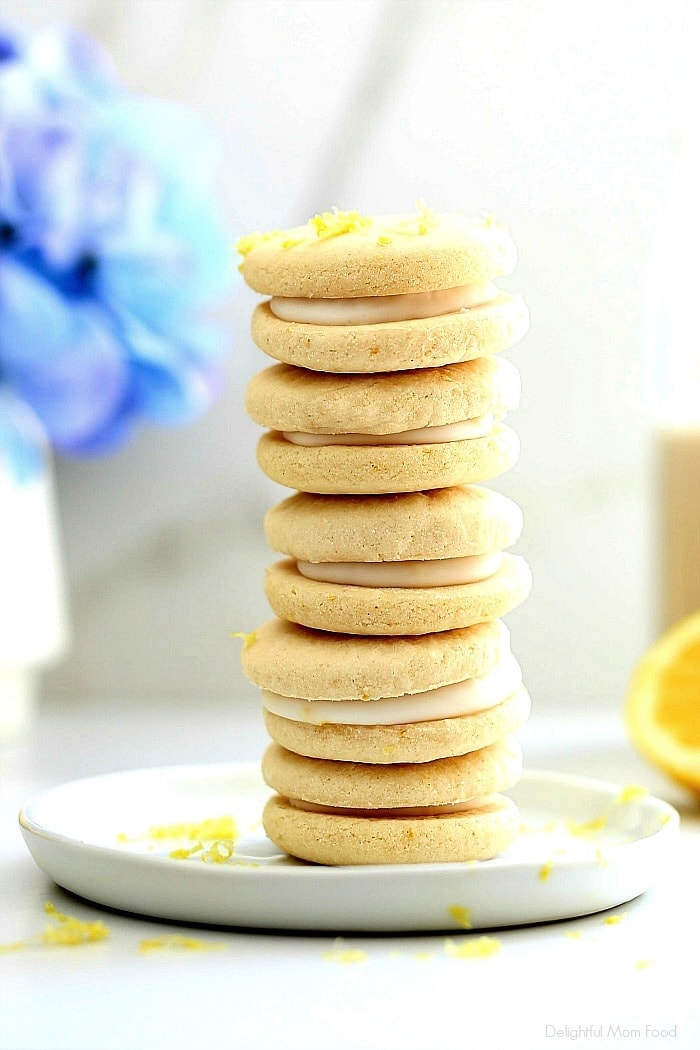 The perfect bright and cheery healthier cookies for spring! This soft lemon cookie recipe is vegan and gluten-free, turned into a sandwich filled with rich lemon icing that soaks into the cookies for a taste that tantalizes your taste buds! #softlemoncookierecipe #veganlemoncookies #lemoncookies #glutenfreelemoncookies #lemonfilledcookies #dessert #treats #easycookierecipe #healthycookierecipe | Recipe at Delightful Mom Food