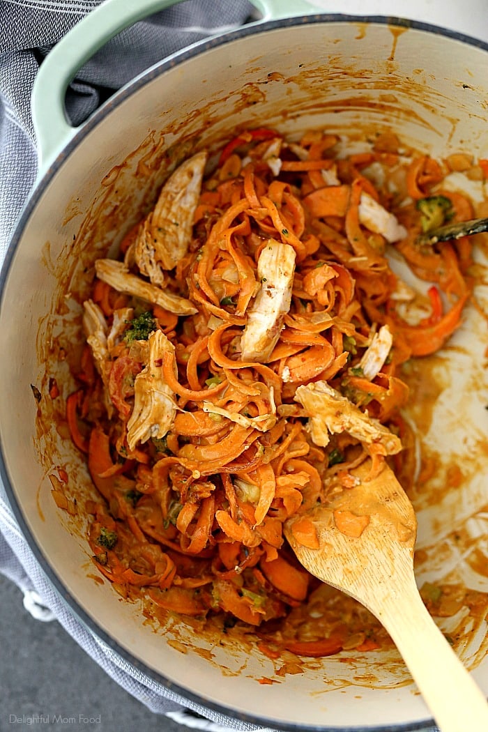 Spicy sweet potato pasta in a creamy red chili and broccoli peanut sauce and tossed with rotisserie chicken that comes together quickly at moments notice. Peanut, ginger, soy, and garlic are what make this spicy sweet potato pasta recipe spectacular! It’s bursting with delicious Asian flavors you’d expect from a Chinese restaurant without the excess fat or expense. #sweetpotatopasta #sweetpotatorecipe #sweetpotato #noodles #zoodles #recipe #dinner #glutenfreepasta | Recipe at Delightful Mom Food