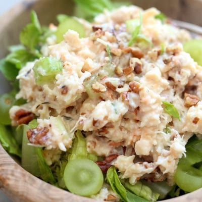 healthy chicken salad with pecans and grapes in a wooden bowl