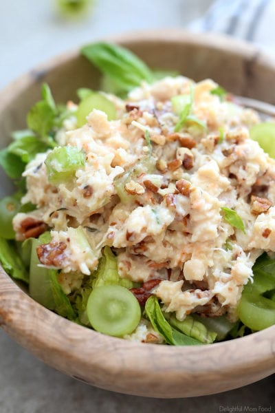 healthy chicken salad with pecans and grapes in a wooden bowl
