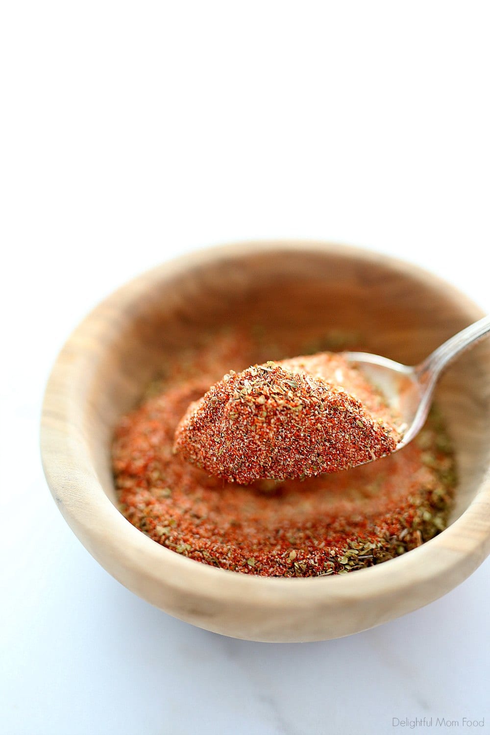 Spicy Cajun shrimp seasoning is a blend of spices and herbs that brings bold kick to seafood recipes! Anytime you are out of store-bought Cajun seasoning mix, make it at home combining paprika, garlic powder, onion powder, salt, pepper, cayenne pepper, oregano and thyme. Use it for all spicy seafood recipes! #Cajunshrimpseasoning #cajun #seasoning #mix #recipe #spices #herbs #homemade | Recipe at Delightful Mom Food