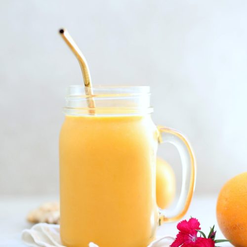 anti inflammatory smoothie recipe in a mason jar with a gold straw set on a white towel