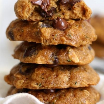 a stack of warm zucchini cookies made with oatmeal and melted chocolate chips